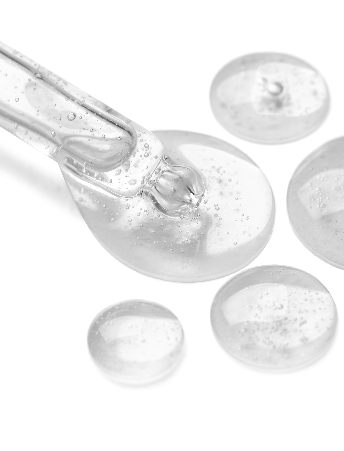 Pipette with Samples of Cosmetic Serum on White Background, Clos